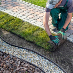 Landscape Gardener Laying Turf For New Lawn